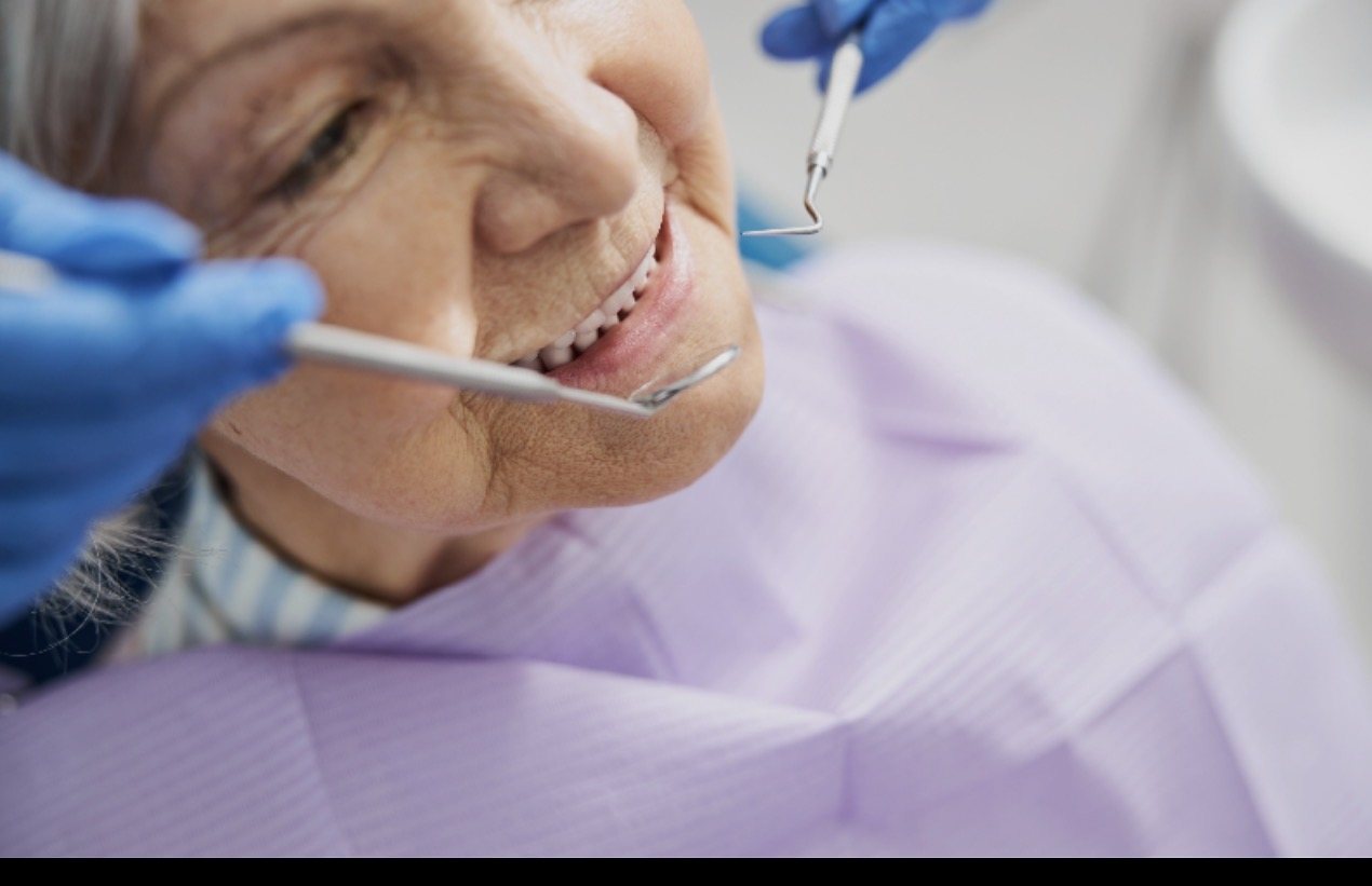 A close-up dental hygiene visit for an older patient.