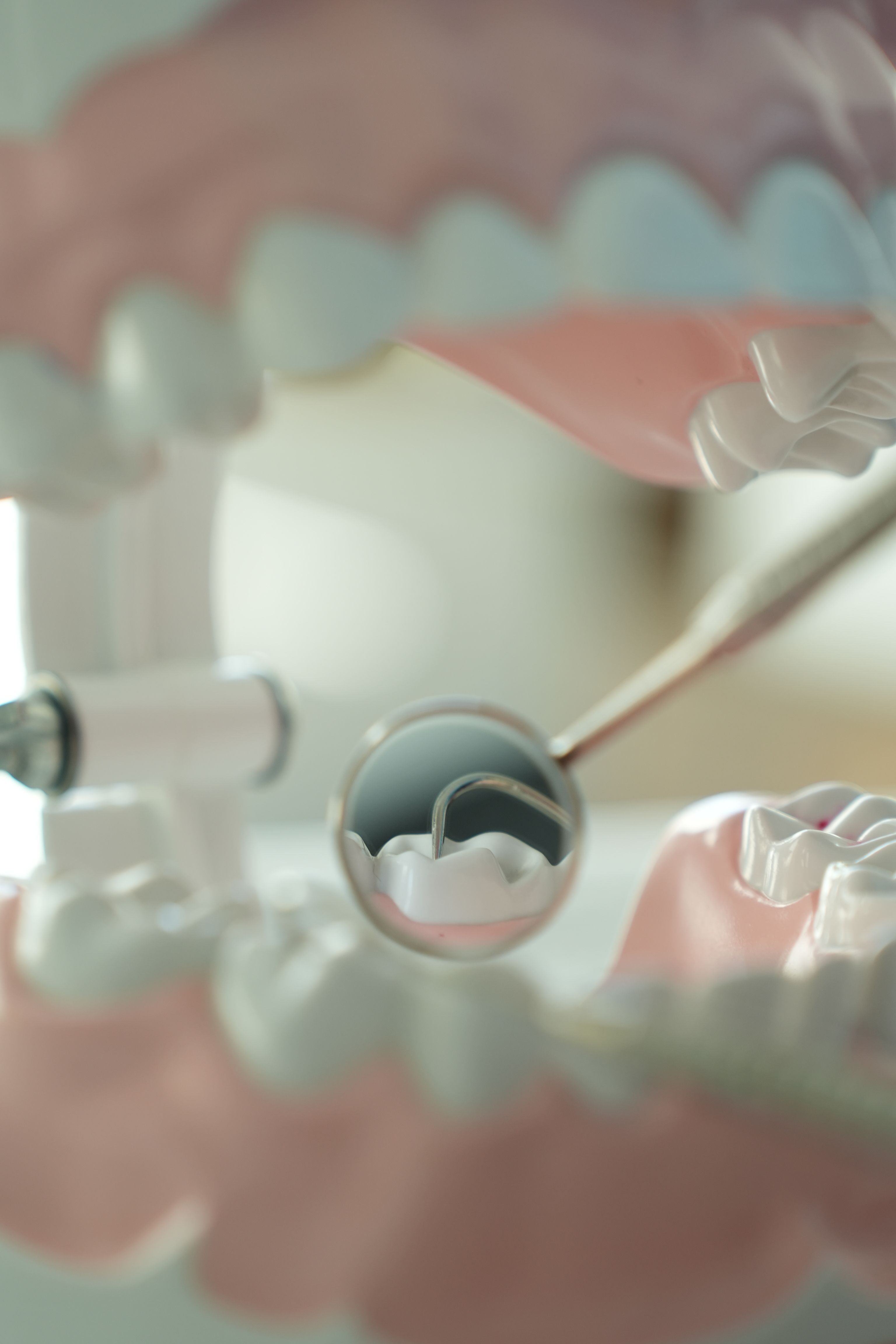 Close-up of a dental mirror and hygiene tools.
